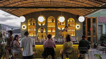 Viajero Hostels | Viajero Oaxaca Hostel | Friends enjoying a cocktail on the rooftop of the hostel in the center of Oaxaca, perfect for travelers and backpackers