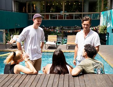 Viajero Hostels | Viajero Buenos Aires | A group of friends talking and enjoying a lovely day in front of the pool at Viajero Buenos Aires.