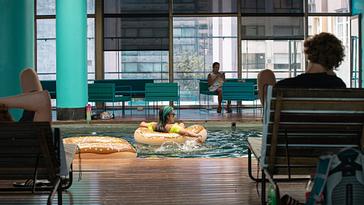 Viajero Hostels | Viajero Buenos Aires | A person using floaties in the indoor pool at Viajero Buenos Aires.