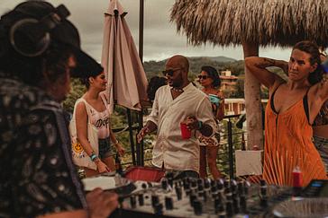 Viajero Hostels | Viajero Sayulita | Group of travelers dancing and having fun at a party held on the terrace of Viajero Sayulita.