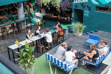Viajero Hostels | Viajero Buenos Aires | People sitting at tables in the Casa Jaguar Bar at Viajero Buenos Aires.