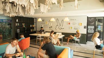 Viajero Hostels | Viajero Buenos Aires | Coworking area at Viajero Buenos Aires, featuring tables, chairs, and sofas for seating.