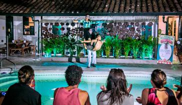 Viajero Hostels | Viajero Cali | Pool area and social space at night at Viajero Hostels Cali.