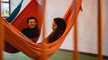 Viajero Hostels | Viajero Salento | Girl lying down relaxing on an orange bed at Viajero Hostels Salento.