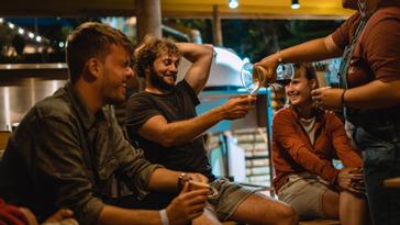 Viajero Hostels | Viajero Salento | Group of tourists enjoying a coffee tasting offered by their accommodation in Salento, Quindío, the coffee land of Colombia.