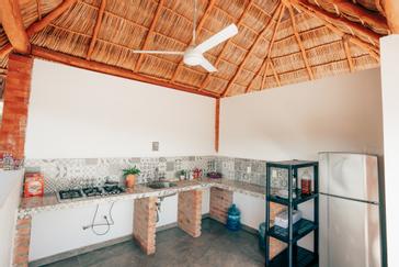 Viajero Hostels | Viajero Sayulita | Shared kitchen for guests with cooking utensils and refrigerator at Viajero Hostels Sayulita.