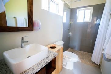 Viajero Hostels | Viajero Sayulita | Private bathroom of a private room with a spacious shower and shower fixtures at Viajero Hostels in Sayulita.